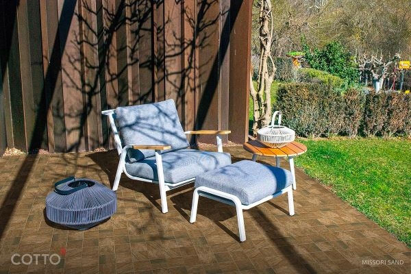 A chair and a table on a patio

Description automatically generated